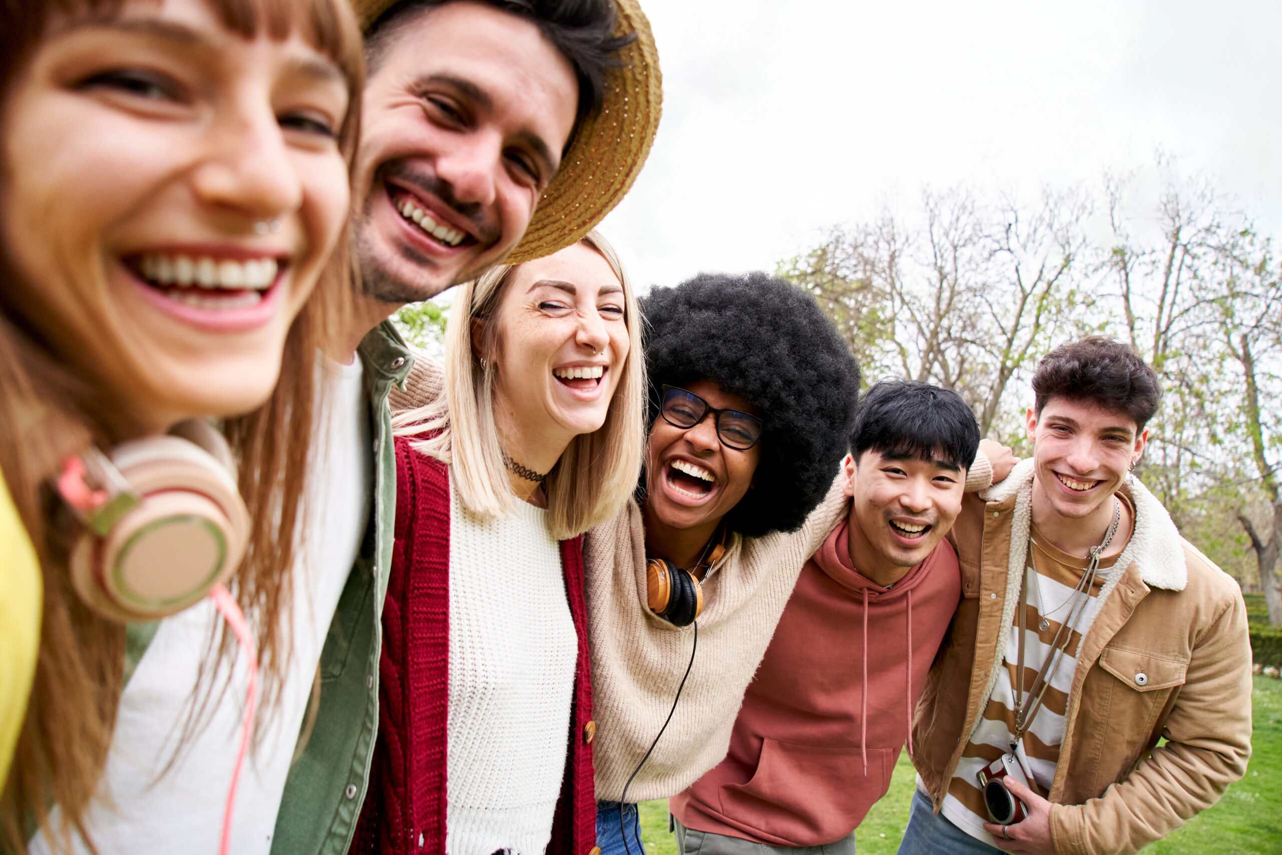Portrait of mixed race group of smiling friends looking at the camera. Young students take a selfie