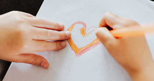 Child drawing a heart